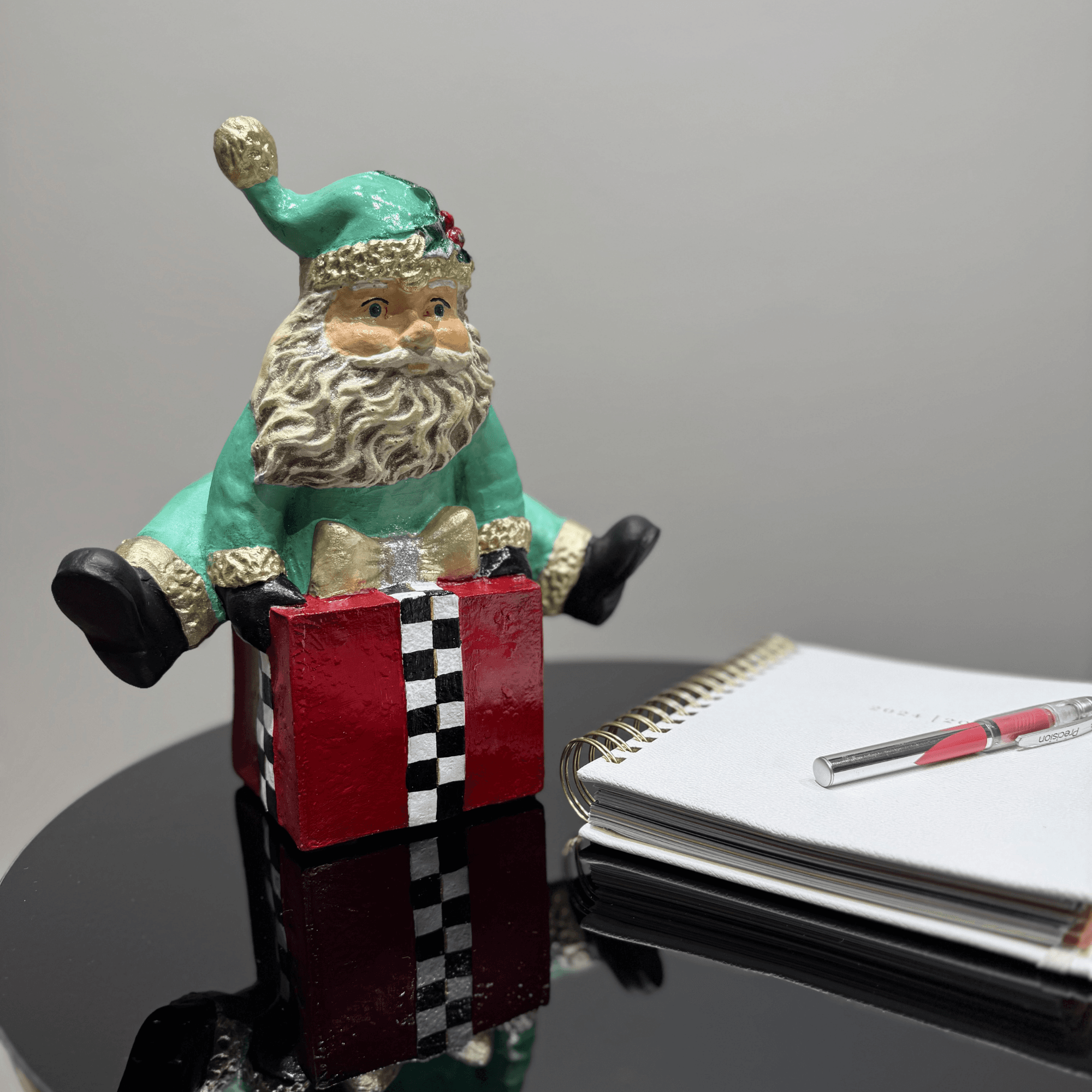 Ferozzi Playful Green Santa on Gift Box Figurine – Handcrafted Whimsical Holiday Decor