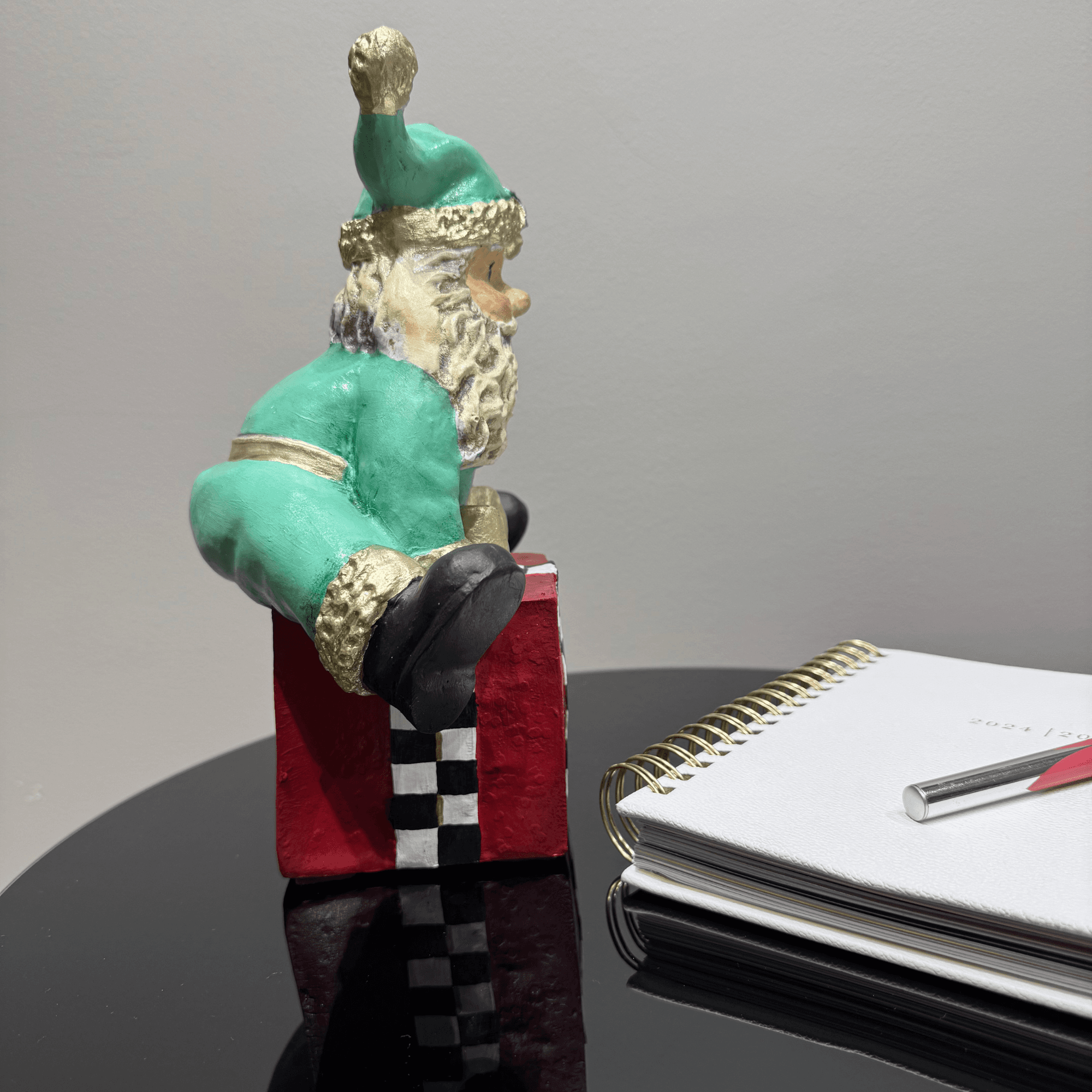 Ferozzi Playful Green Santa on Gift Box Figurine – Handcrafted Whimsical Holiday Decor